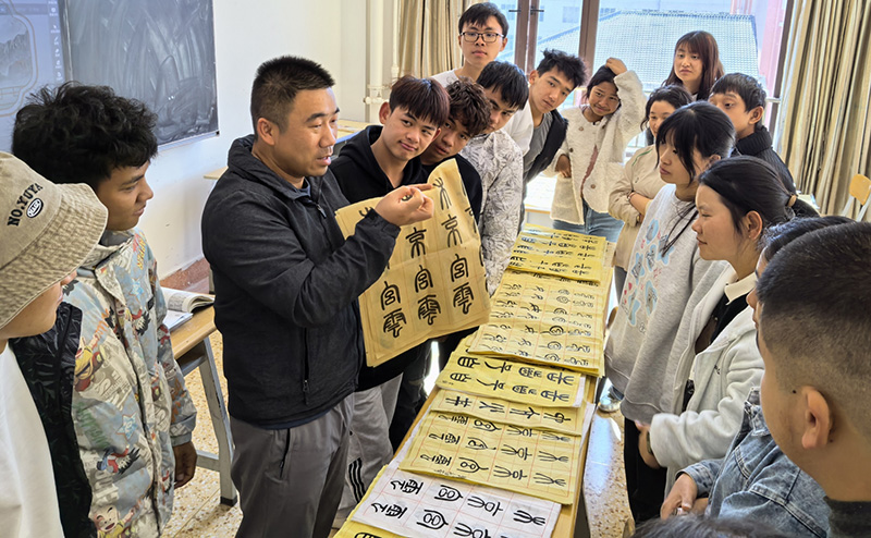 徐润刚用手语为学生们讲解书法篆刻。KY开元集团官网供图